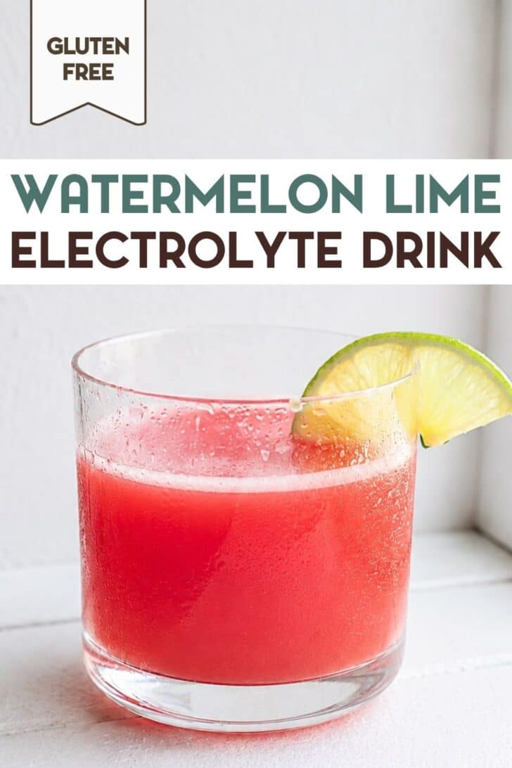 Glass of chilled watermelon drink garnished with a fresh lime wedge with a text overlay for Pinterest.