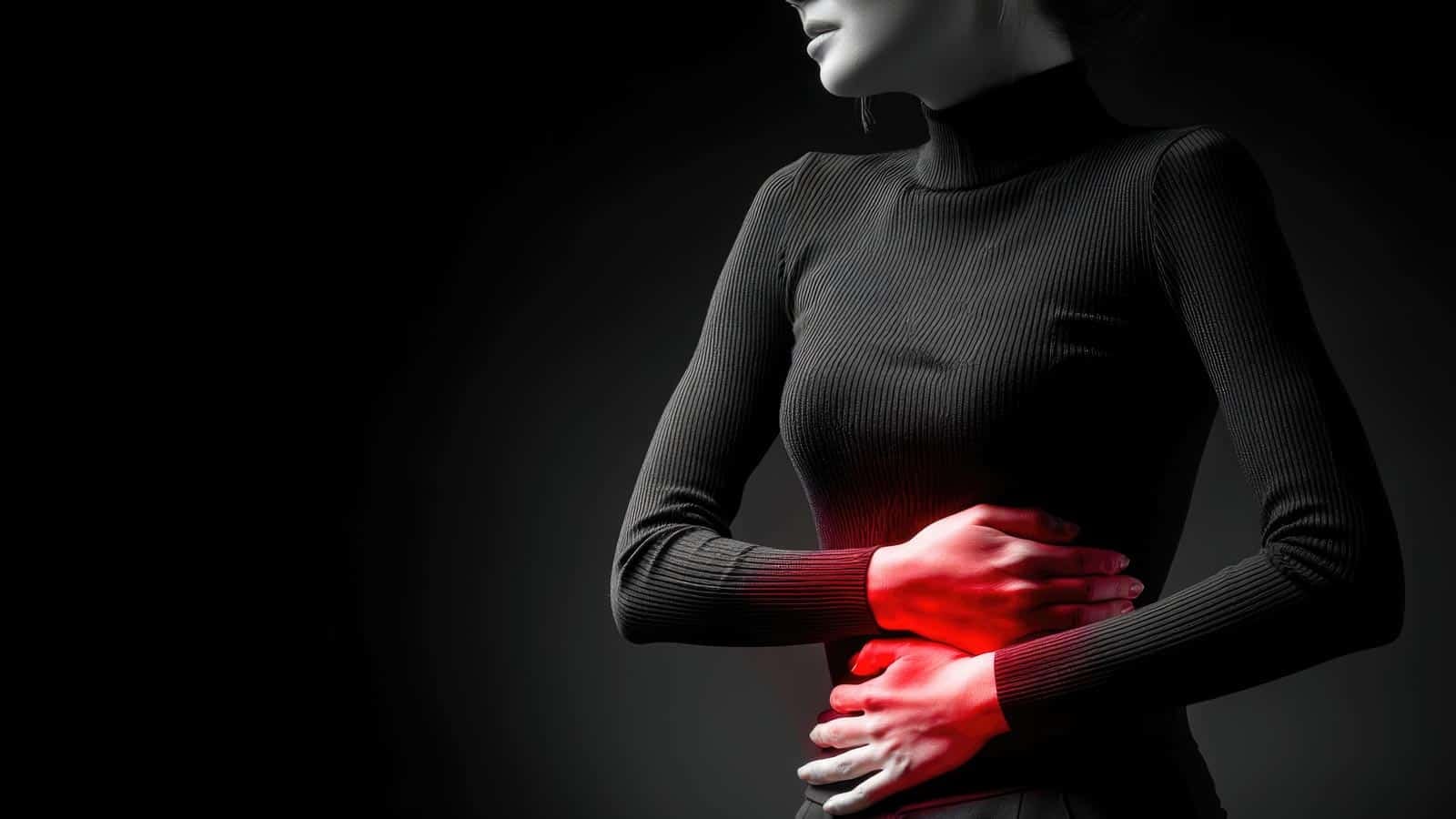Woman with gut pain. IBS. Holding stomach. marselin888 via 123rf