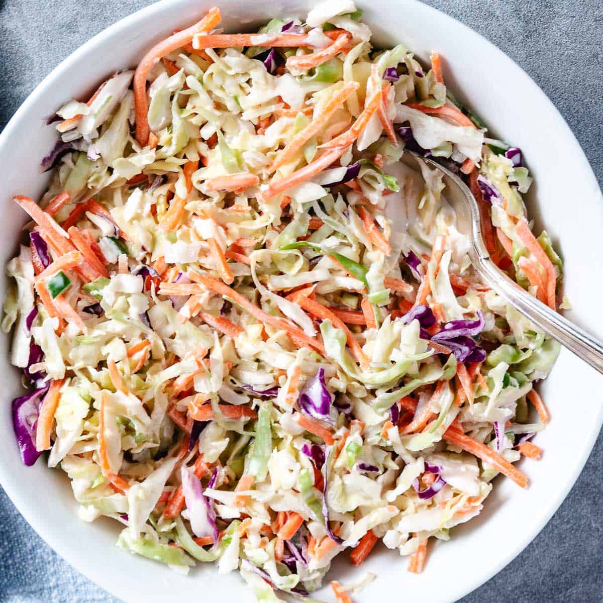 sweet creamy coleslaw with cabbage, carrots, peppers, and creamy dressing