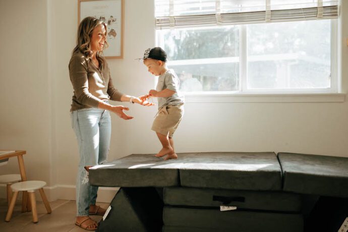 mom and toddler playing on leo mats