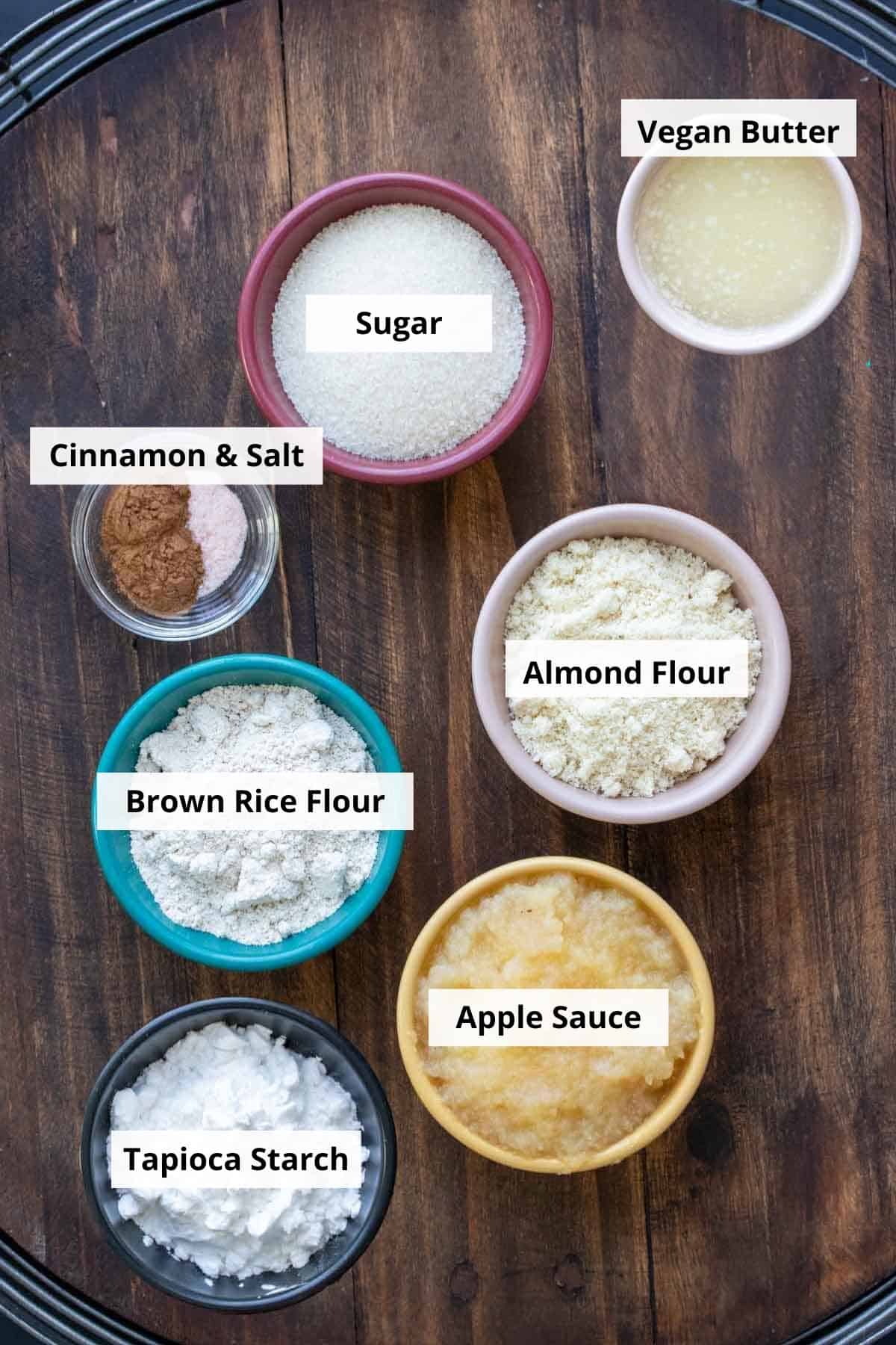 Different colored bowls filled with ingredients to make vegan churros.