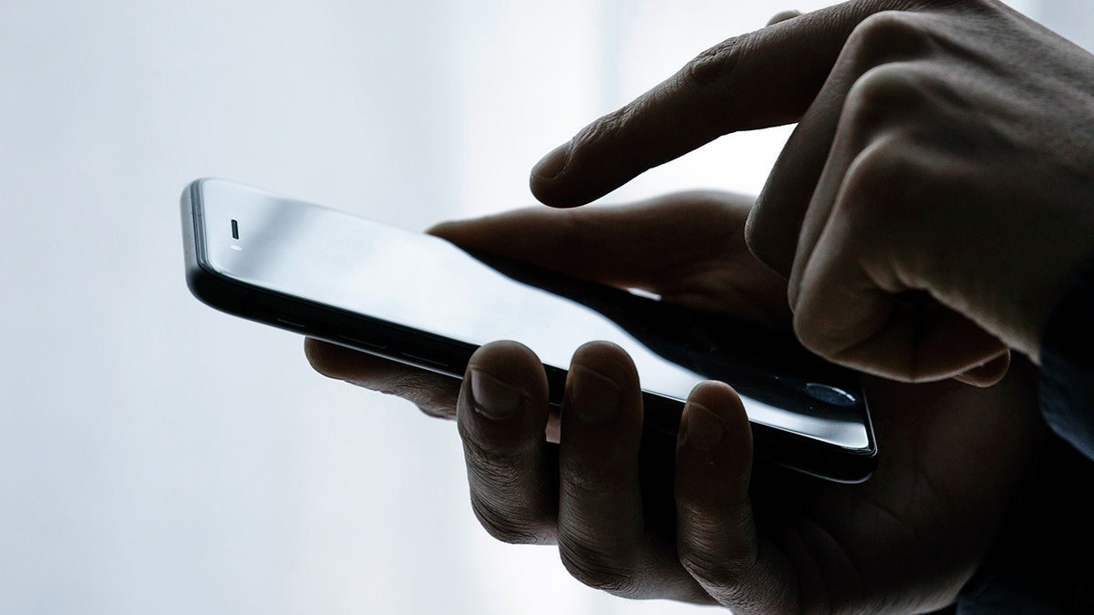 A person using their iPhone.
