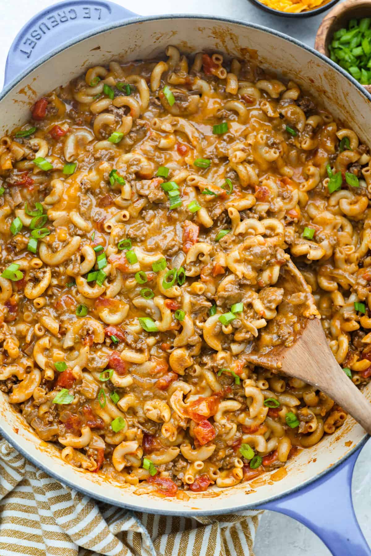 If your family loves tacos and mac and cheese, this one pan taco mac is about to become a weeknight favorite! It's cheesy, hearty, packed with Tex-Mex flavor, and comes together in one skillet in just 30 minutes. Large skillet of one pan Taco Mac.