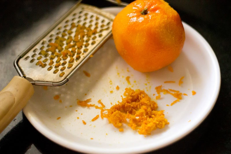 Zesting orange for orange biscuits recipe.