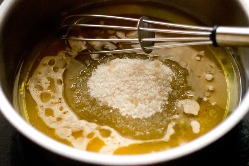Orange juice, oil and sugar in a bowl.