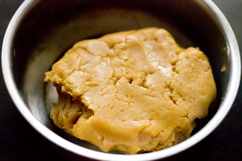 Orange cookie dough in bowl.