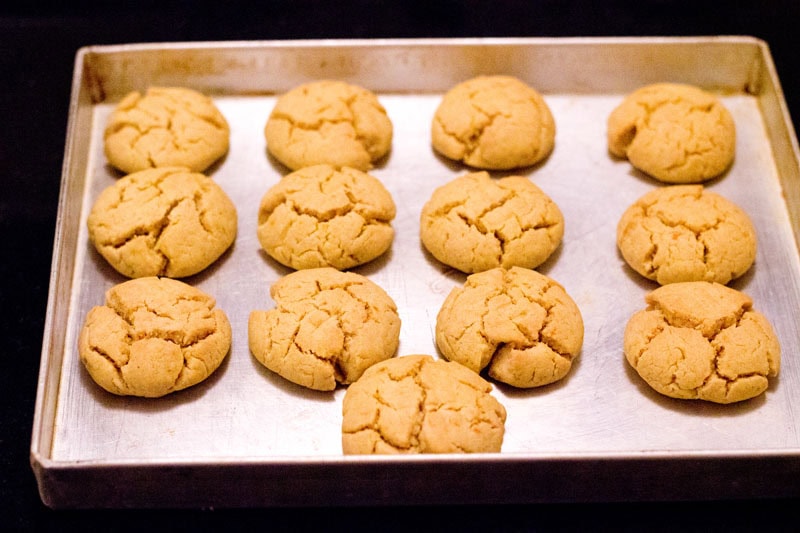 Baked orange biscuits on baking tray.