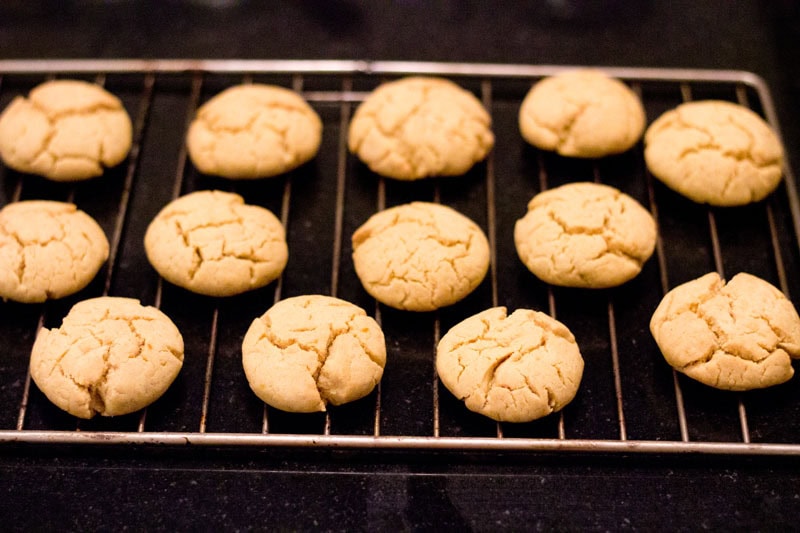Cooling orange biscuits on a wired tray.