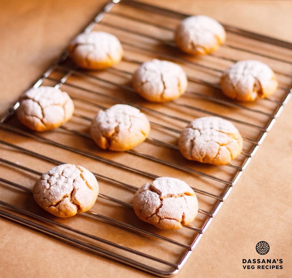 Homemade orange cookies on a rack.