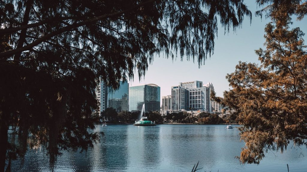 Downtown Orlando skyline and the Lake Eola fountain framed by cypress trees