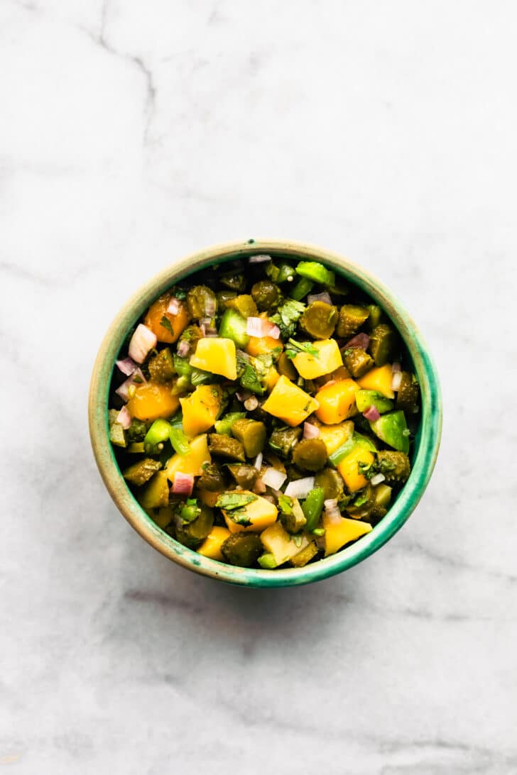 Close-up of sweet and tangy pickle salsa with mango, herbs, and diced vegetables.