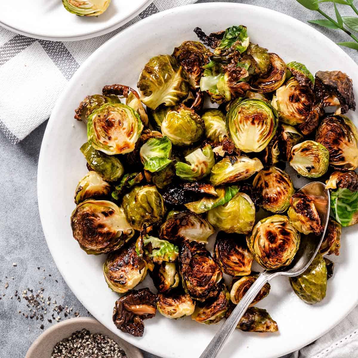 roasted brussels sprouts on a white plate.
