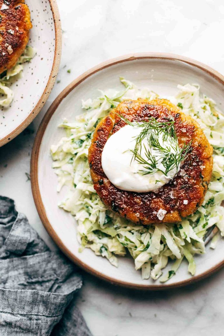 Salmon burger on top of slaw.