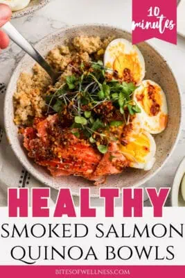 Bowl filled with quinoa, smoked salmon, hard boiled eggs topped with microgreens.