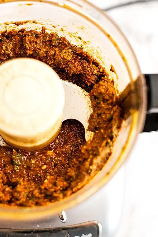 Close up of sundried tomato pesto in a food rpcoessor.