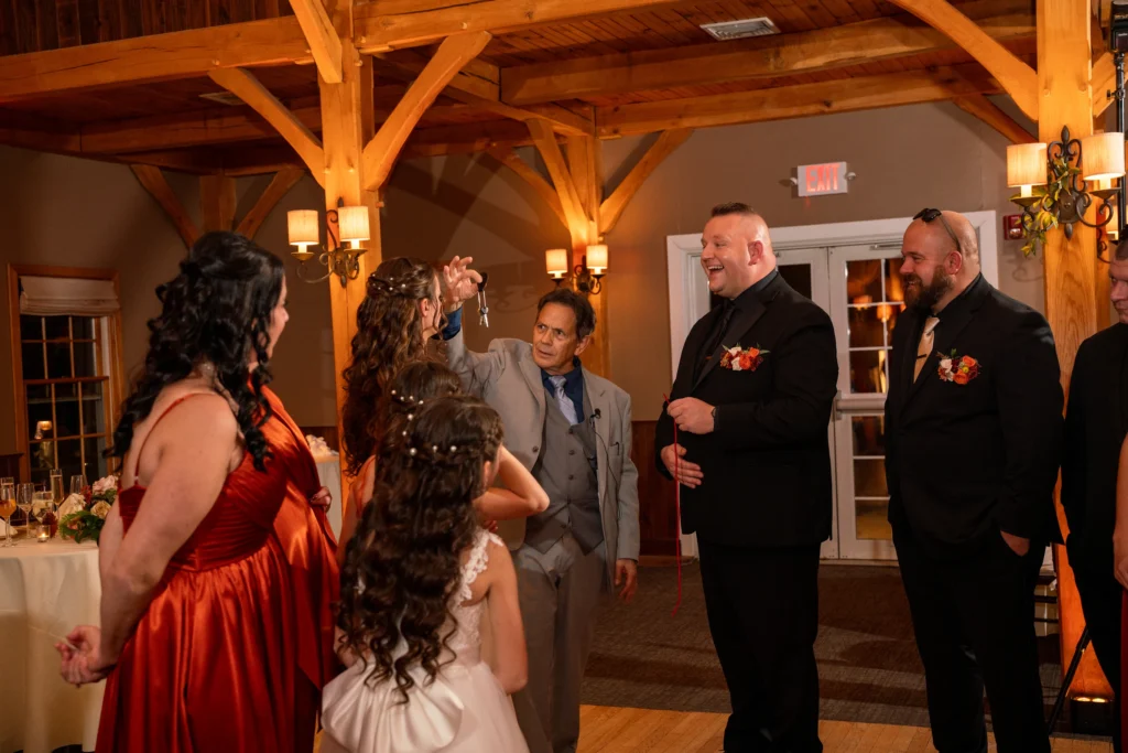 The Magic of Joe Ferranti Wedding magician Joe Ferranti performing interactive closeup magic during a lively cocktail hour in Massachusetts