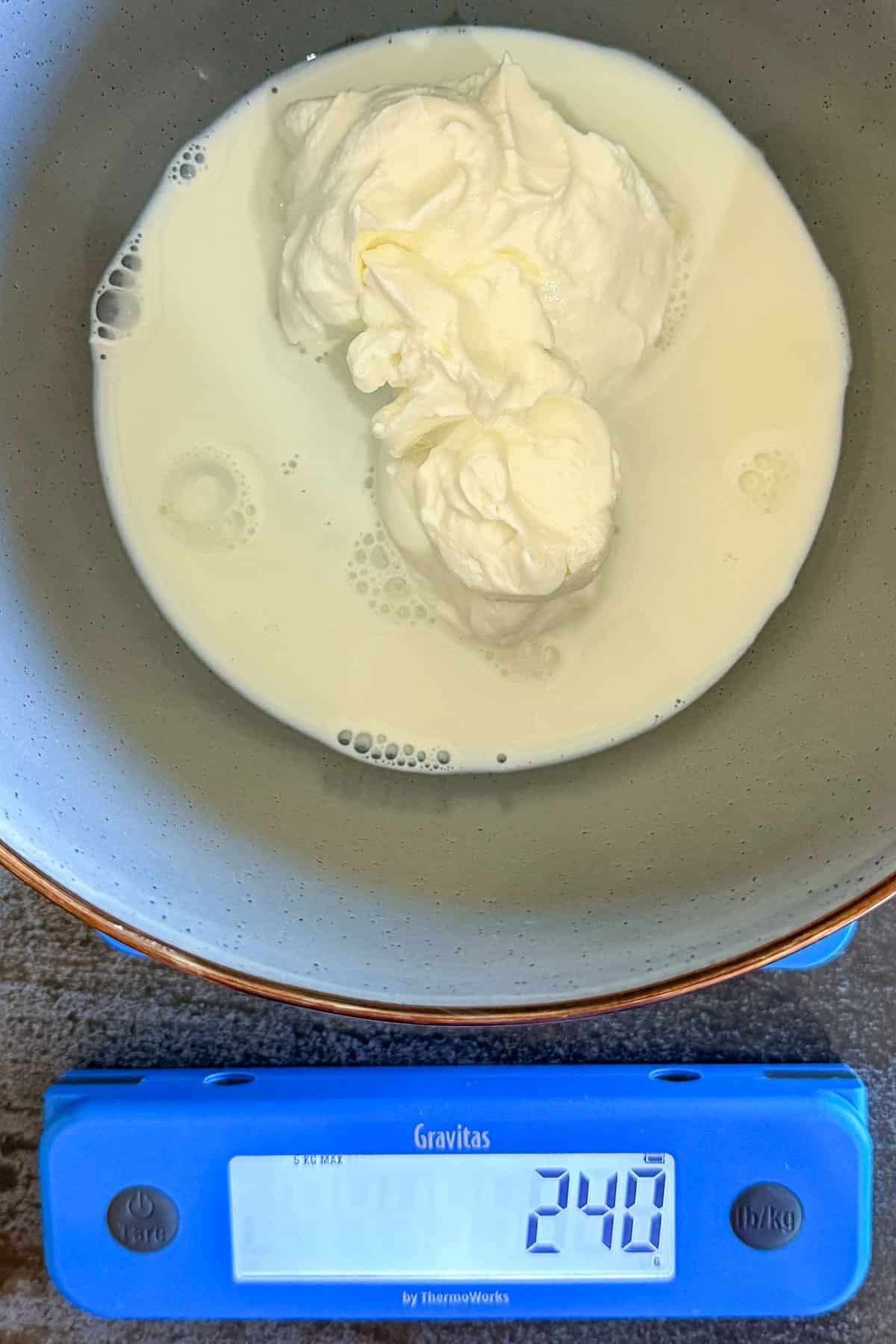 Mixing Greek yogurt and milk.