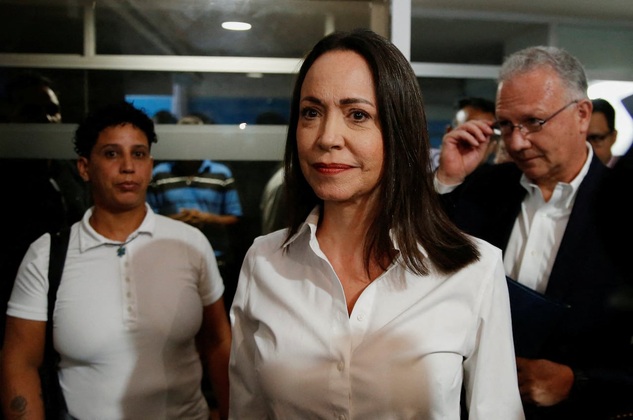 A woman stands in a crowd.
