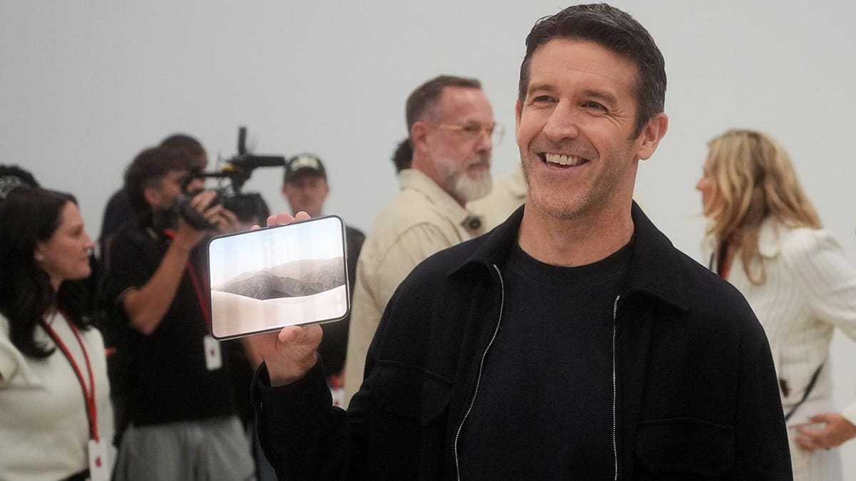 John Ternus holds up the iPhone Duo.
