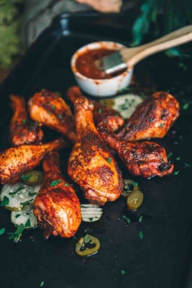 Smoked chicken drumsticks on a baking sheet.