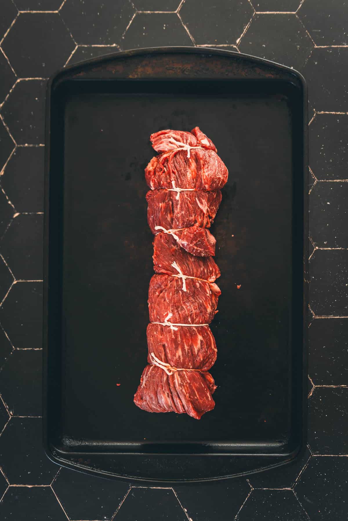 Beef tenderloin tied with butcher's twine to make an even roast.