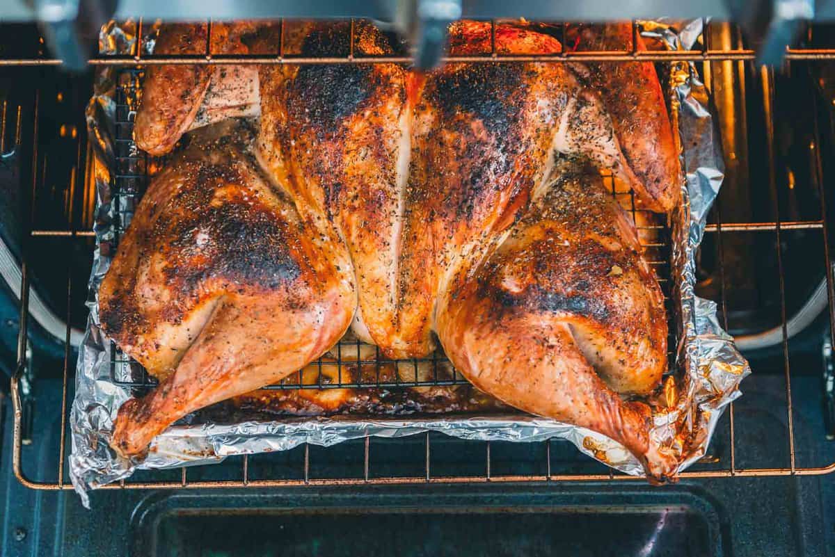 Golden brown turkey on an oven rack.