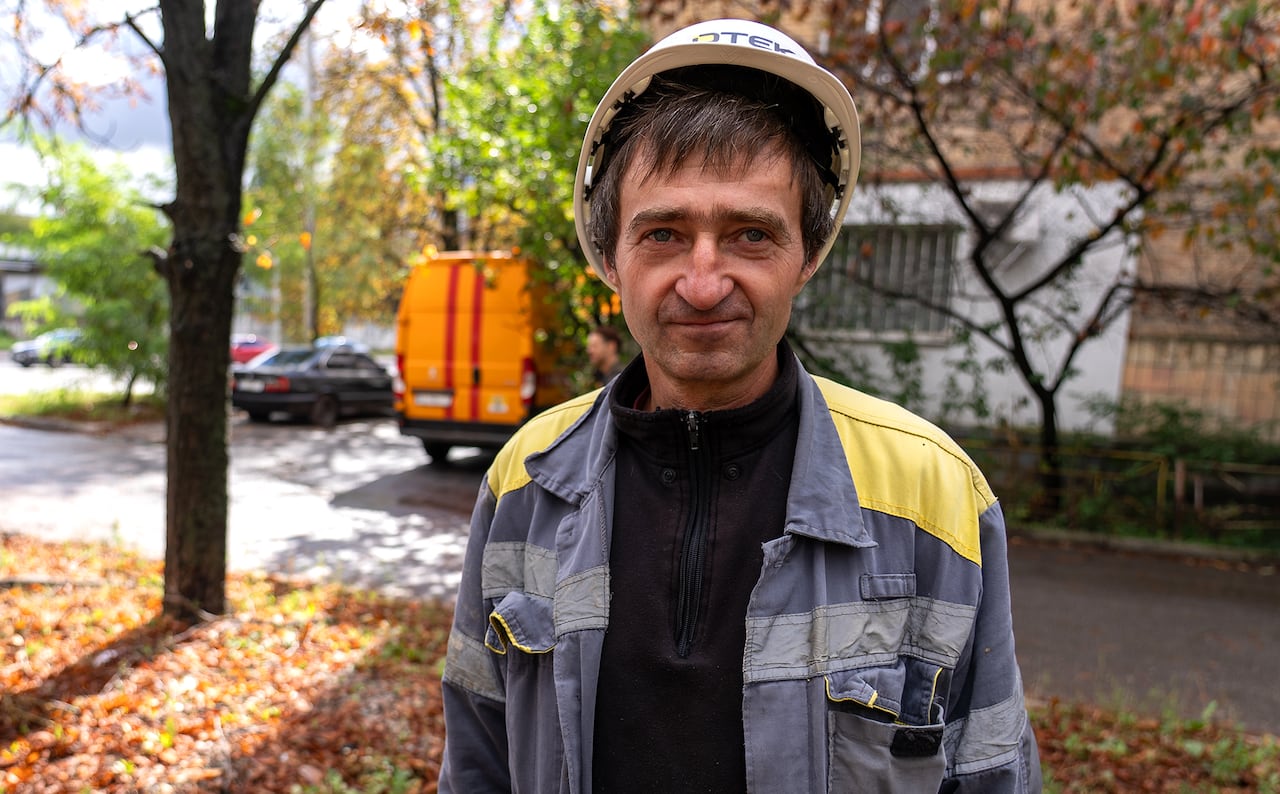 A man in a hard hat looks at the camera.
