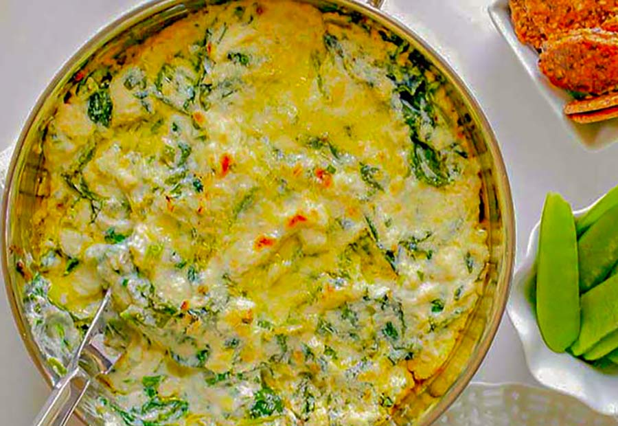 bubbling creamy spinach and ricotta flavoured dip in a bowl appetizer