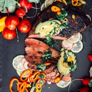 sliced trip tip topped with chimichurri and avocado