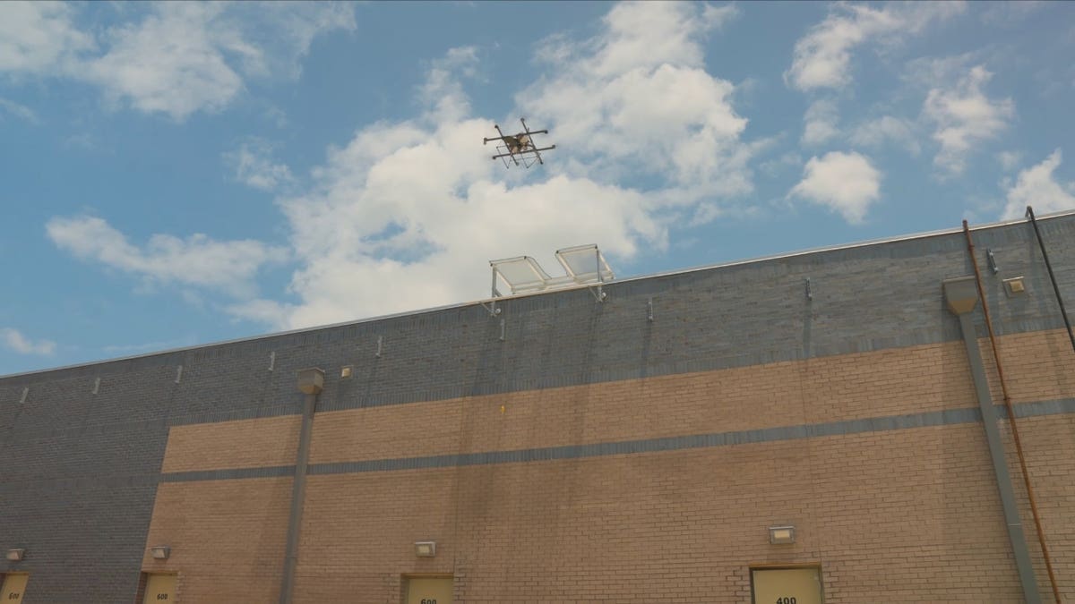 A drone taking off from a roof.