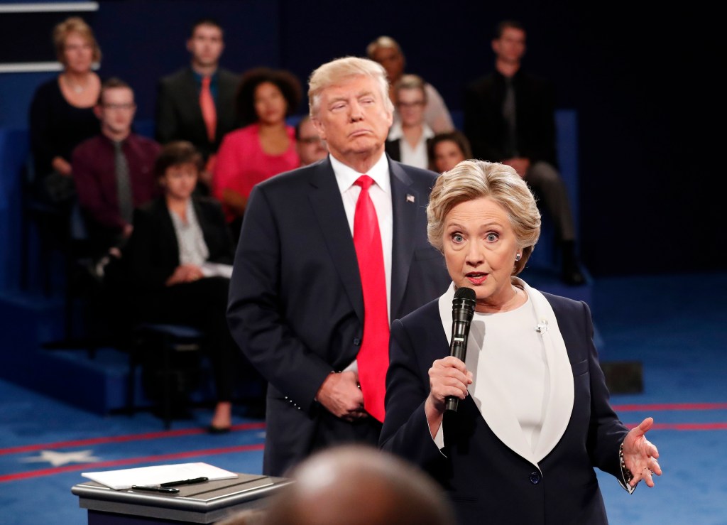Democratic presidential nominee Hillary Clinton, right, speaks as Republican presidential nominee Donald Trump listens during the second presidential debate at Washington University in St. Louis, Sunday, Oct. 9, 2016. (Rick T. Wilking/Pool via AP)..
