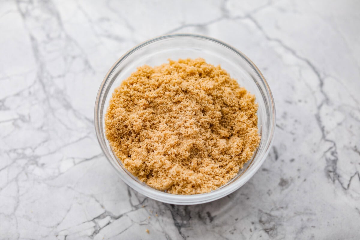 Bacon brown sugar chicken tenders are sweet, smoky, and slightly spicy. Made with only a few simple ingredients, they're like candied bacon hugging juicy chicken without being overly sweet. Great as a main or appetizer, and always a total hit! Bowl of brown sugar and seasonings.