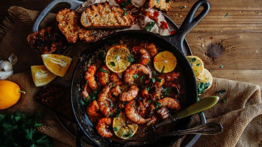 platter of bbq shrimp in skillet.