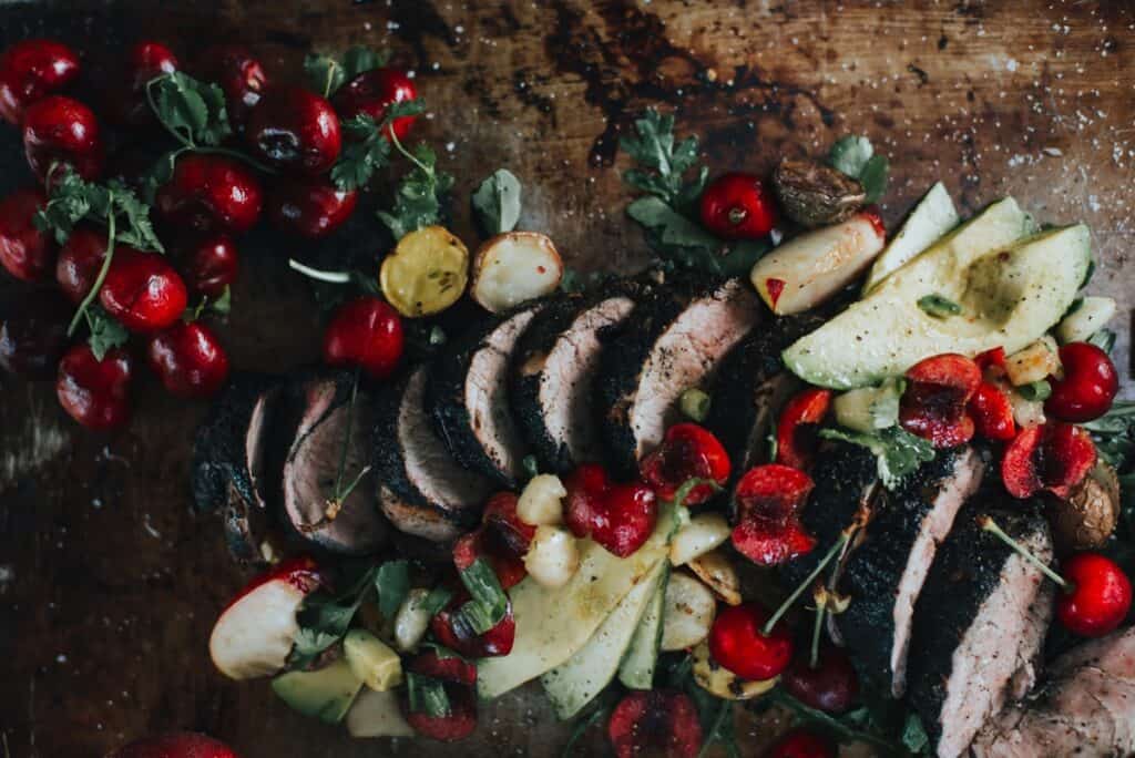 Grilled pork tenderloin sliced with stone fruit.