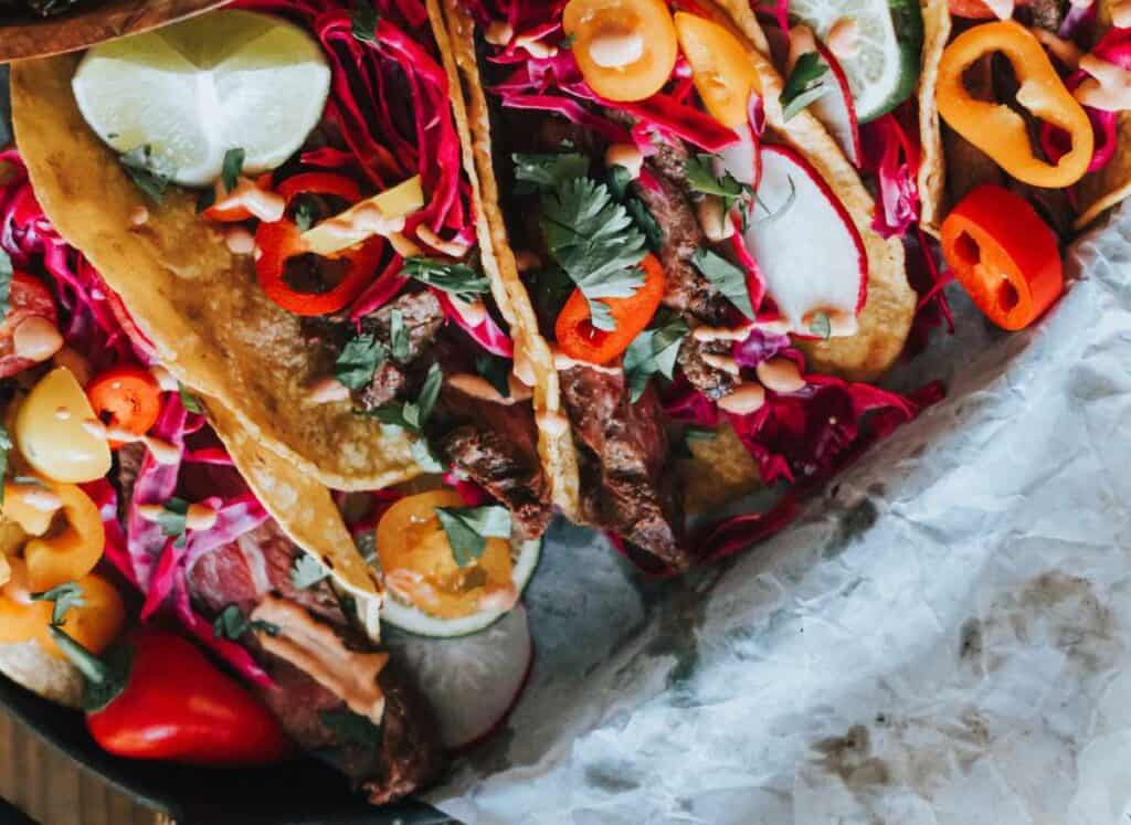 Overhead of colorful tacos.