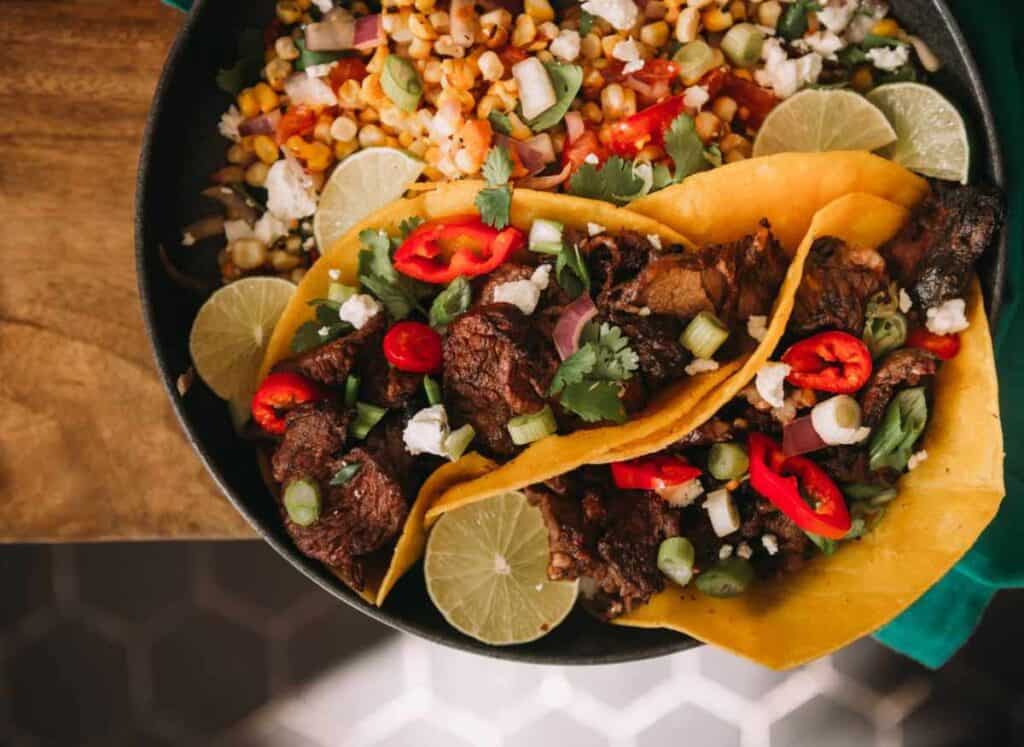 Tacos in a bowl with corn.