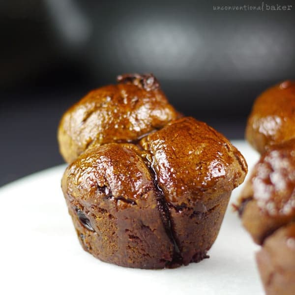 Single Monkey Bread on white plate with other monkey breads beside it.