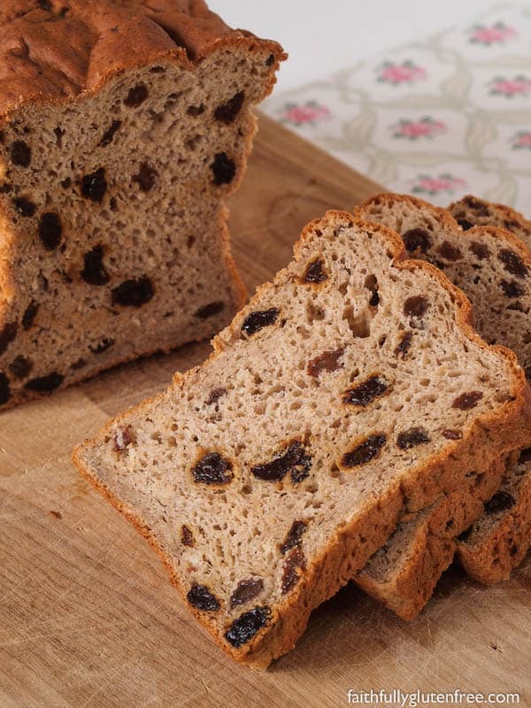 Gluten-Free Oatmeal Cinnamon Raisin Bread on wooden cutting board. One of 65 gluten-free loaf bread recipes featured on gfe. [GlutenFreeEasily.com]
