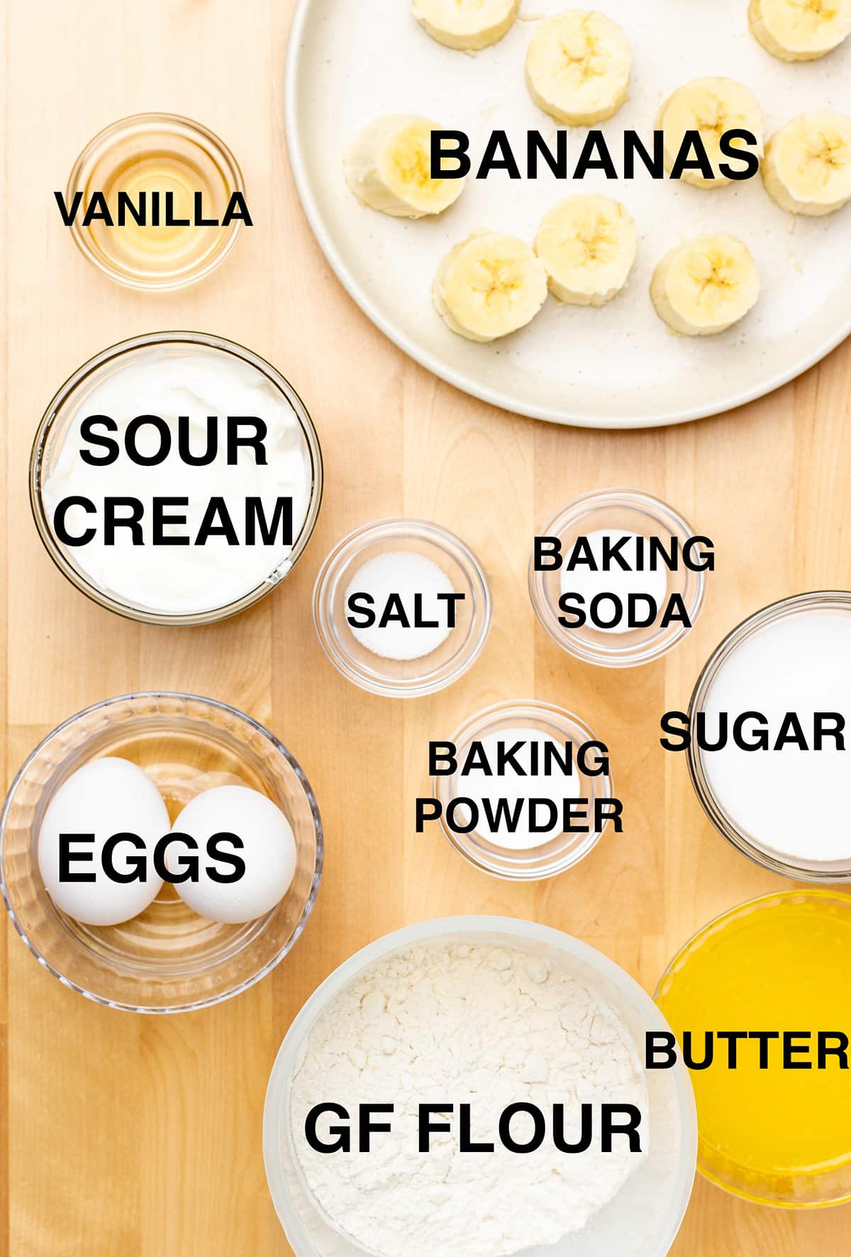 Ingredients for the recipe including sliced bananas, vanilla, sour cream, eggs, melted butter and more.
