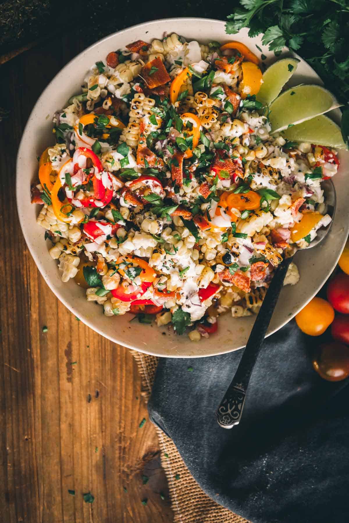 Overhead shot of a white bowl with colorful summer salad. 