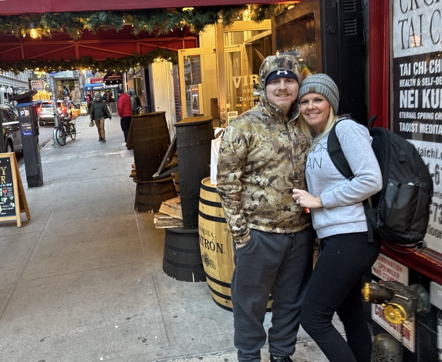 A photo of Mason Henderson and his mother, Tabitha Lowe, outside a shop in New York.