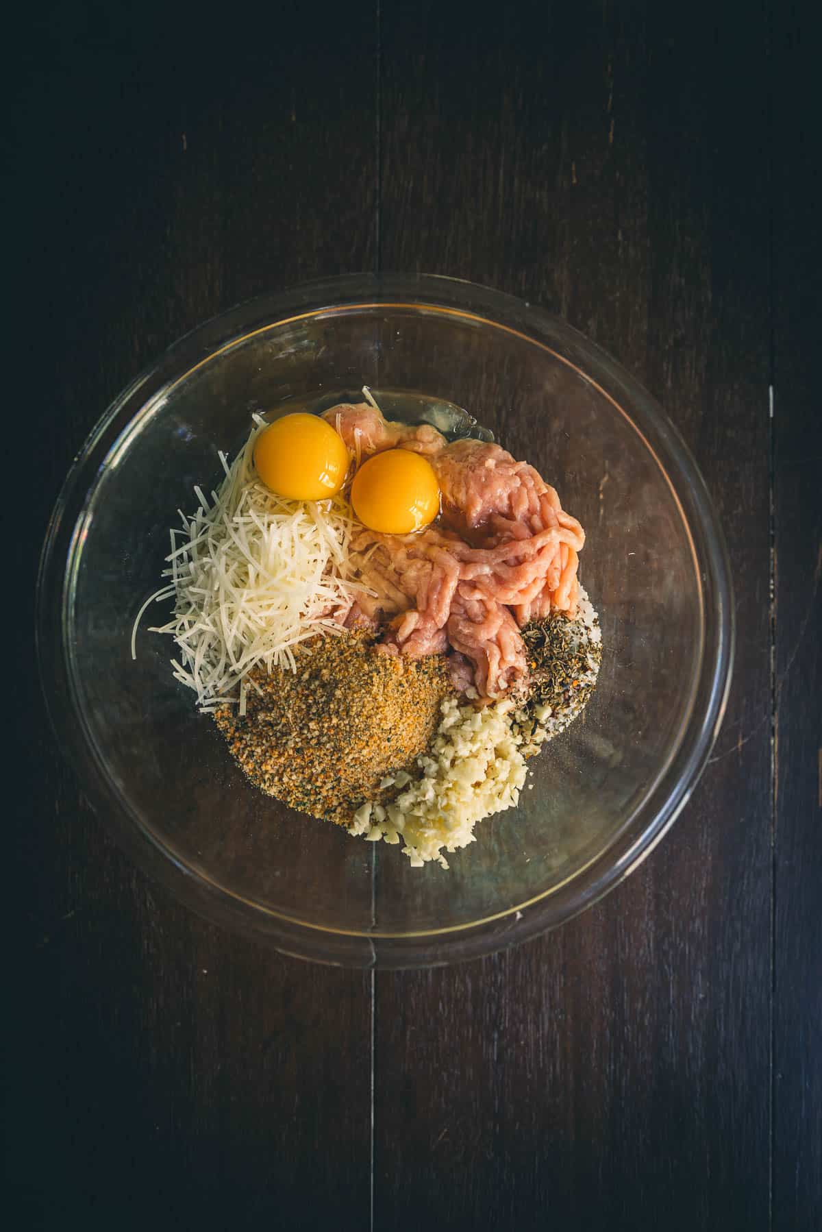 All the ingredients for the meatball mixture in a bowl. 
