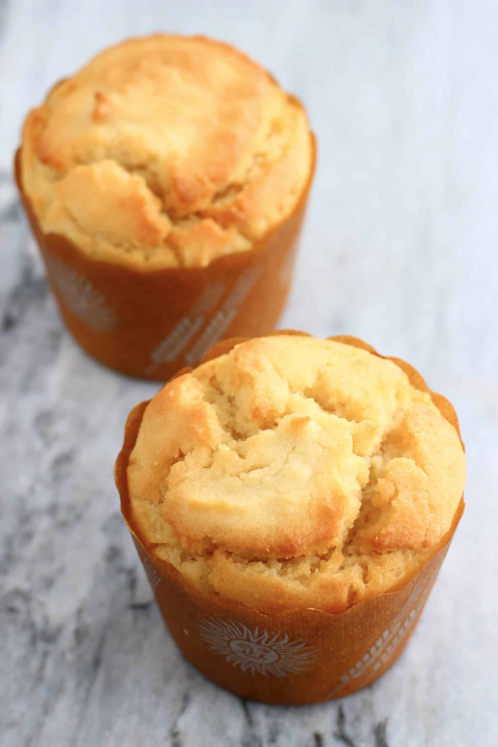 Two gluten-free vegan yogurt muffins on a marble background