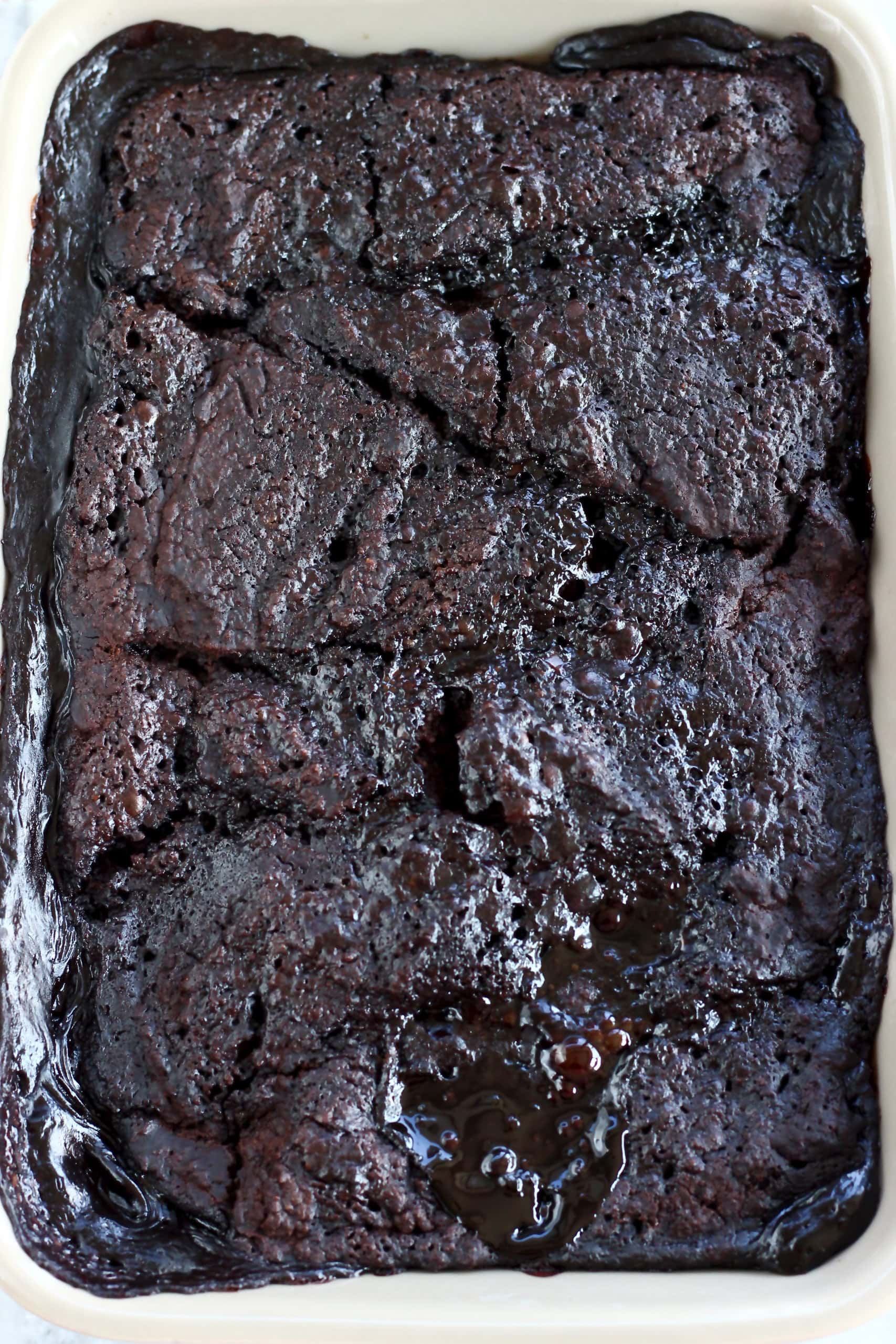 Baked vegan chocolate fudge pudding in a rectangular baking dish