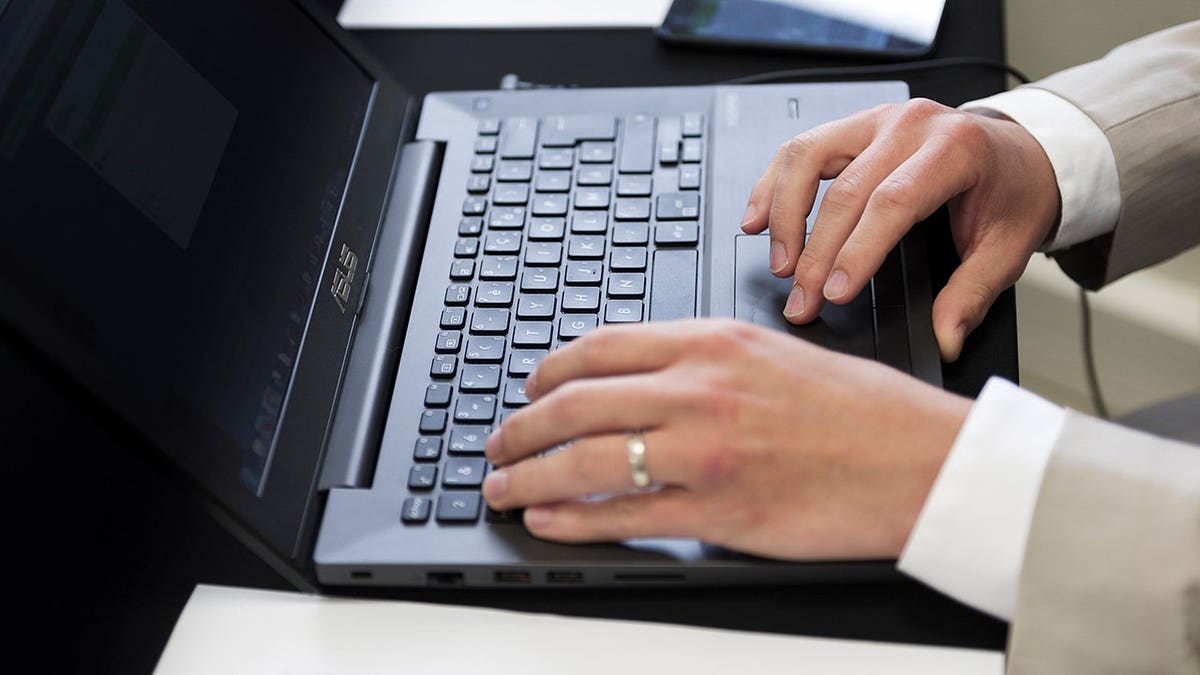 Man typing on his computer.