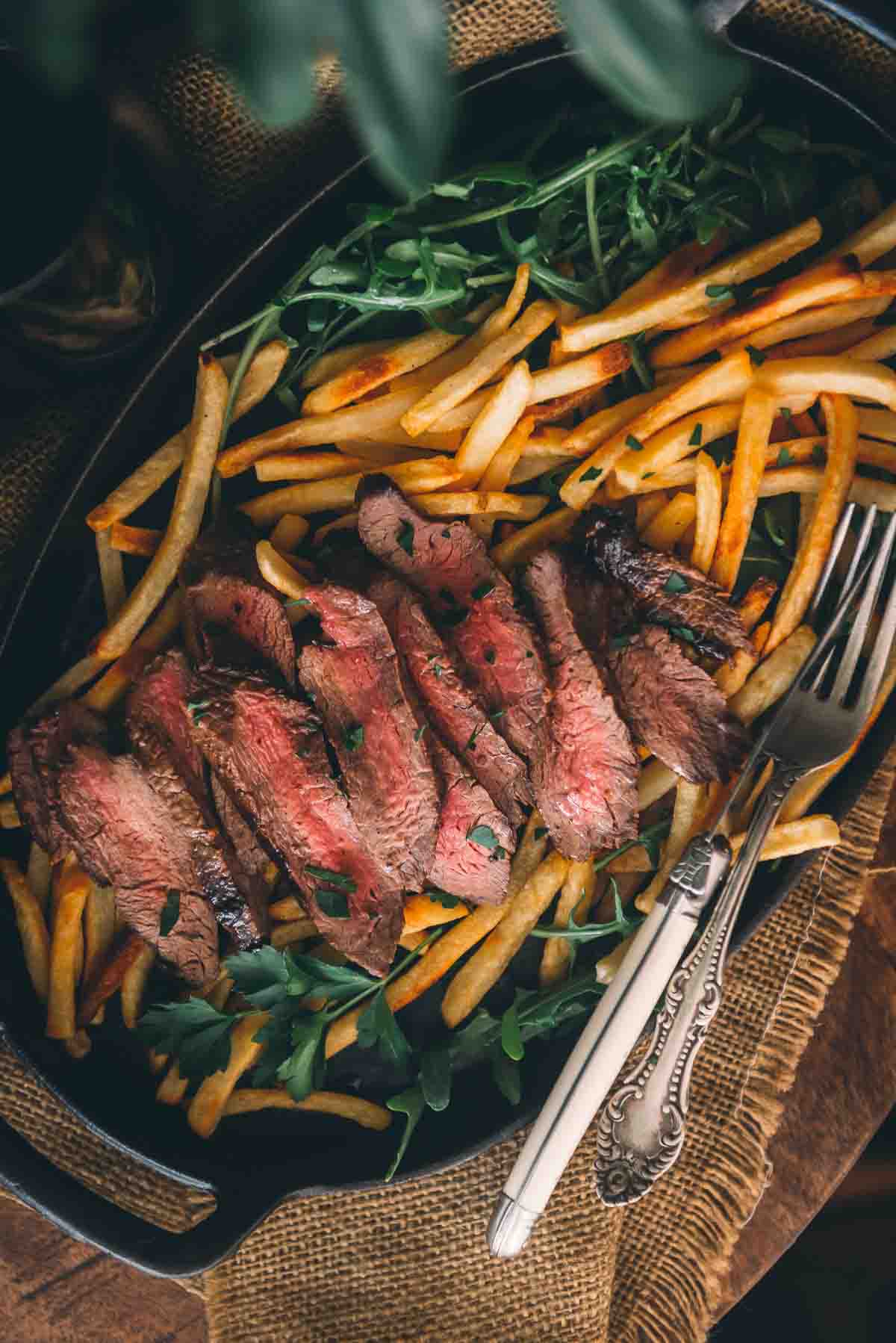 Platter of sliced steak ready for serving. 