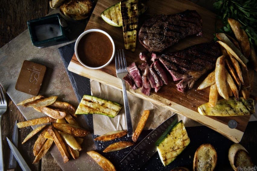 Overhead shot of steaks and fries.