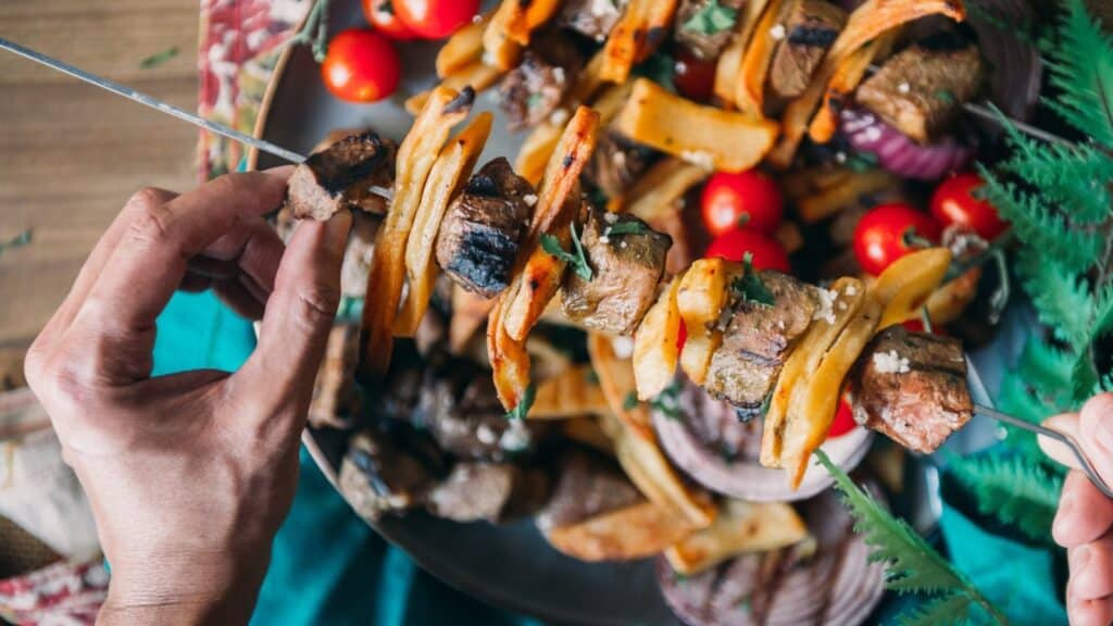 Steak and potatoes on a skewer.