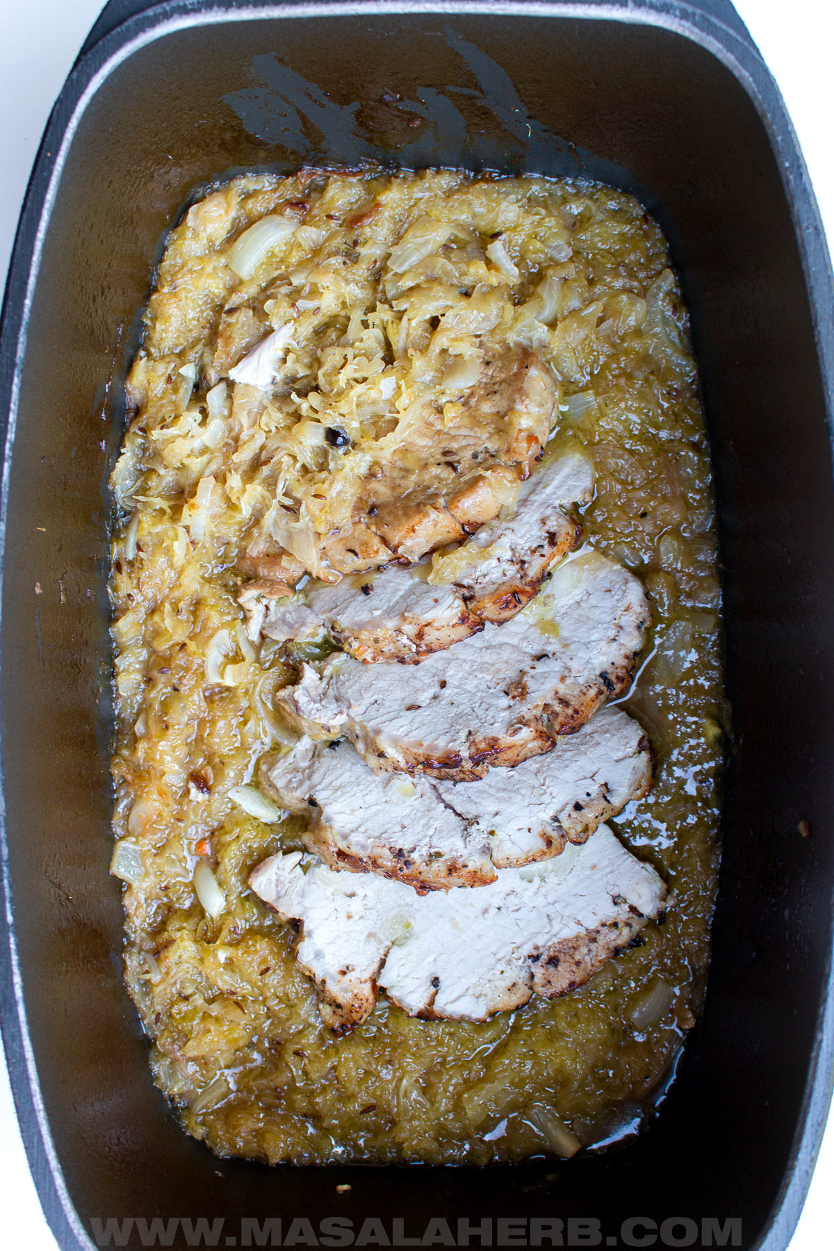 pork loin slices in sauerkraut served