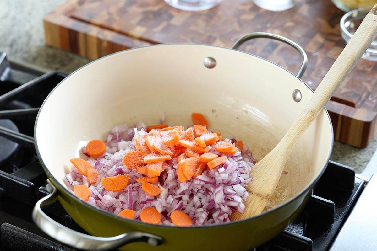 adding veggies to the pan